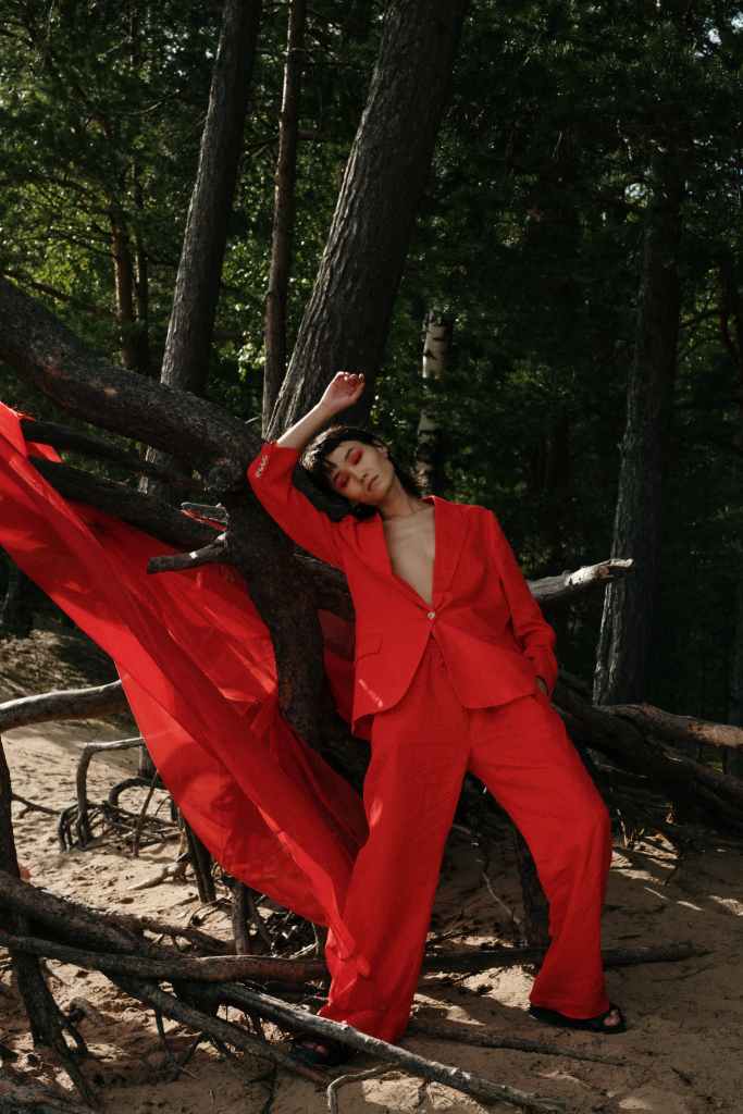 woman wearing red colored pantsuit posing for picture