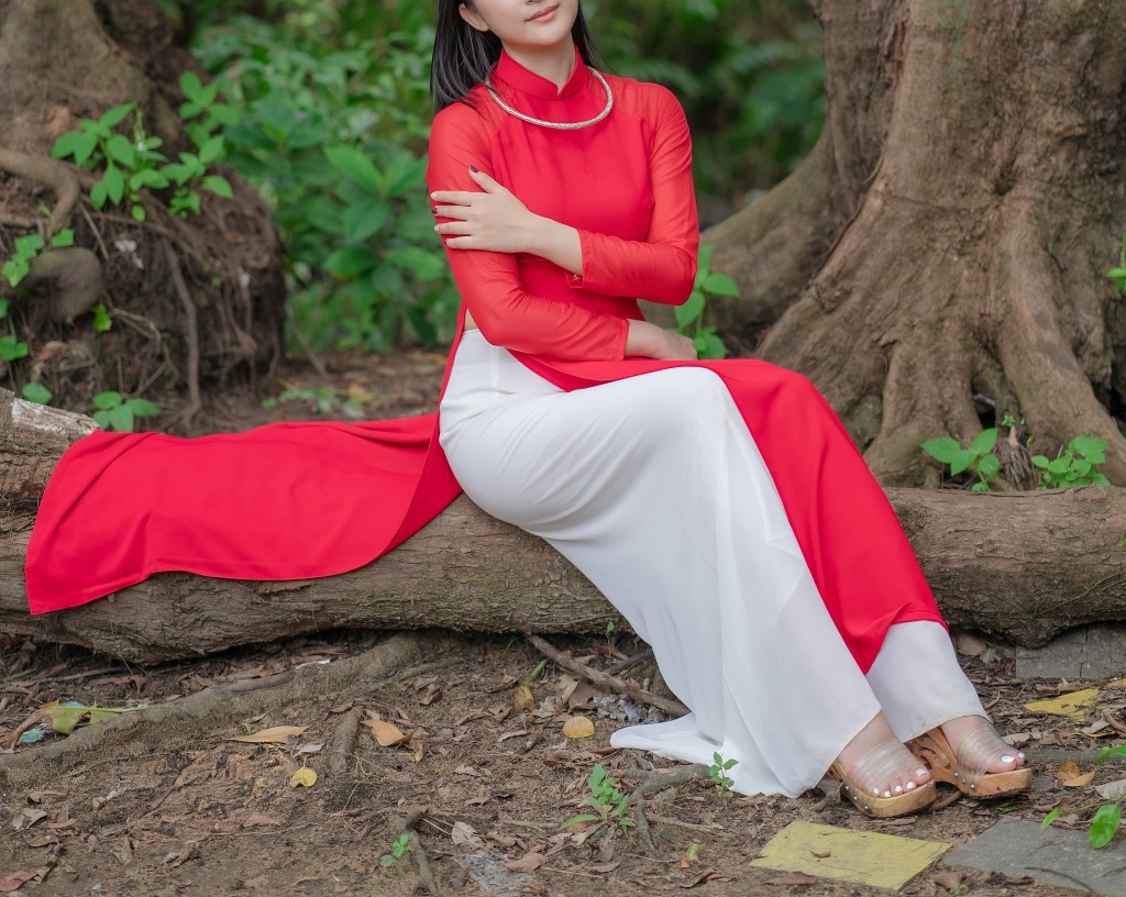 woman sitting on the bark of the tree wearing red and white classic color blocking combination dress